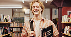 Portrait, man and student with book in library for learning, financial study and business course. Person, finance textbook and knowledge with investment information, education exam and growth advice