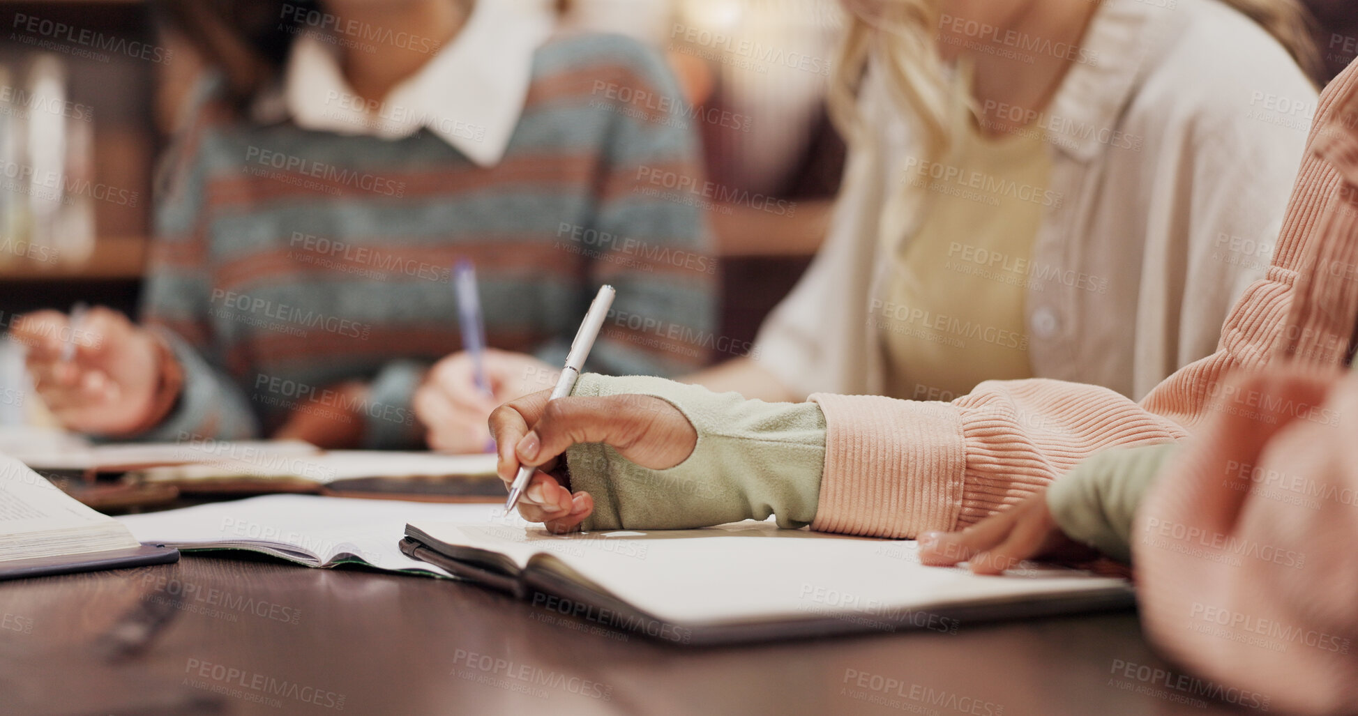 Buy stock photo Library, writing and hands of people with notebook for journal, learning and knowledge in education. College, campus and students with paper for studying, support and preparation for university test
