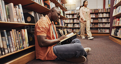 Buy stock photo Student, black man and reading on floor in library for literature, research and studying of knowledge. Person, novel and search for academic information, school book and learning for education growth