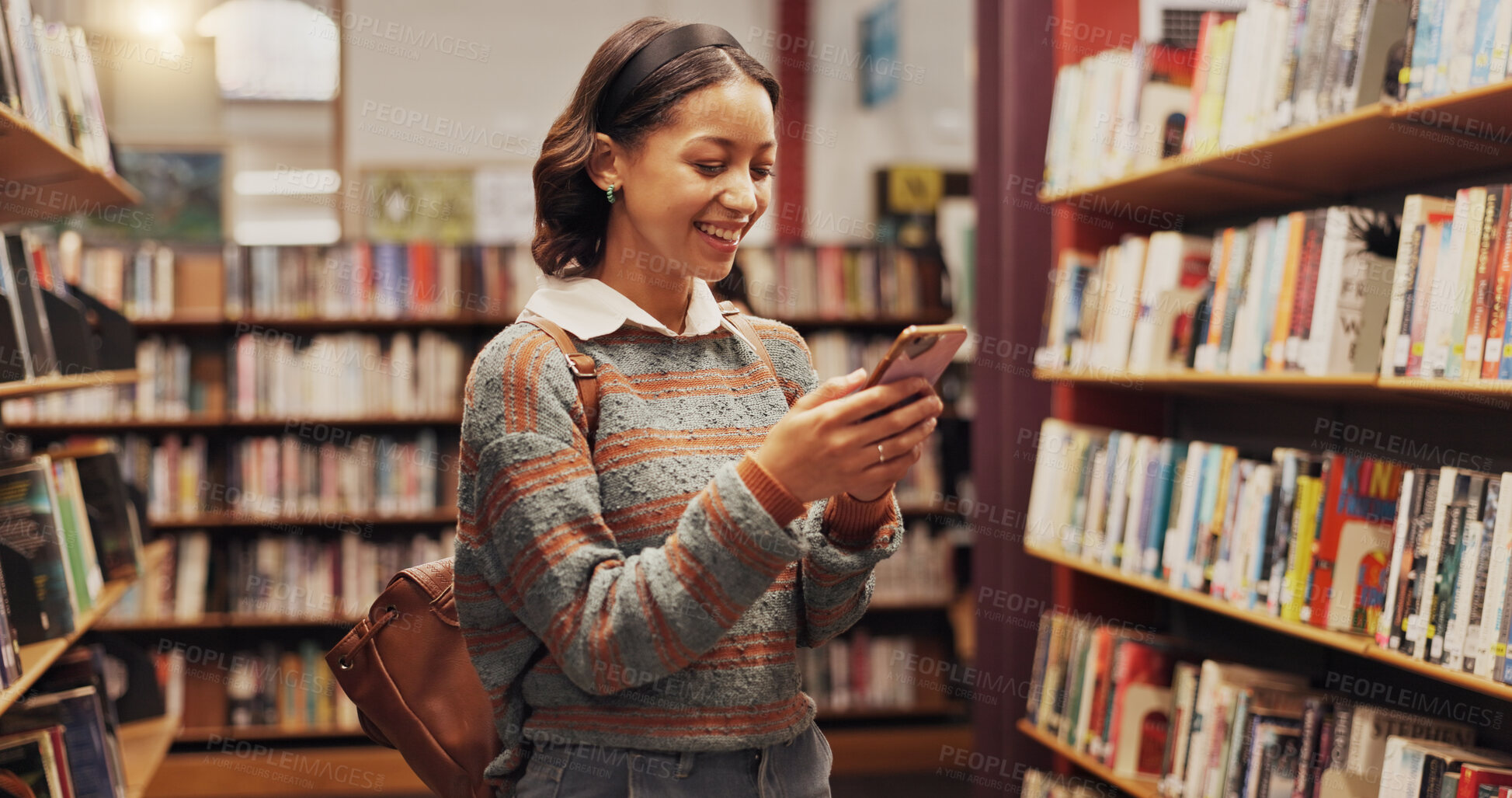 Buy stock photo Learning, phone and student woman in library to search for books or study material. App, education and social media with smile of happy person on college or university campus for school scholarship