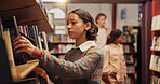 Woman, student and shelf with books in library for choice, textbook search and studying for exam. Female person, decision or literature information for knowledge, education and assessment at college
