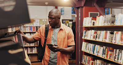 Buy stock photo Education, phone and student black man in library to search for books or study material. App, information and social media with person on college or university campus for learning or scholarship