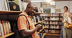 Learning, phone and student black man in library to search for books or study material. App, education and social media with happy person on college or university campus for school scholarship