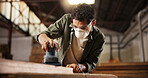 Man, carpenter or wood with sander at workshop for polish, craft or building project. Male person, woodworking and machine with mask for wooden repair, design or restoration at construction warehouse