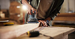 Person, hands and carpenter with sander at workshop for polish, craft or lumber project. Closeup, wood worker and sanding machine with plank, timber or beam for wooden repair, design or restoration