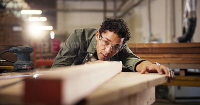 Buy stock photo Man, carpenter or wood with plank on workbench for polish, craft or timber project at workshop. Male person, woodworker or safety glasses for wooden repair, lumber restoration or design at warehouse