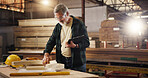 Wood, clipboard and carpenter with man in factory for design production, furniture or manufacturing. Sketching, handyman and framework with craftsman for building project, inspection and construction