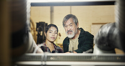 Buy stock photo Carpenter, woman and man with ideas, small business and collaboration with mature mentor in workshop. Serious, artisan and people with plans for production, craftsmanship and creativity for project