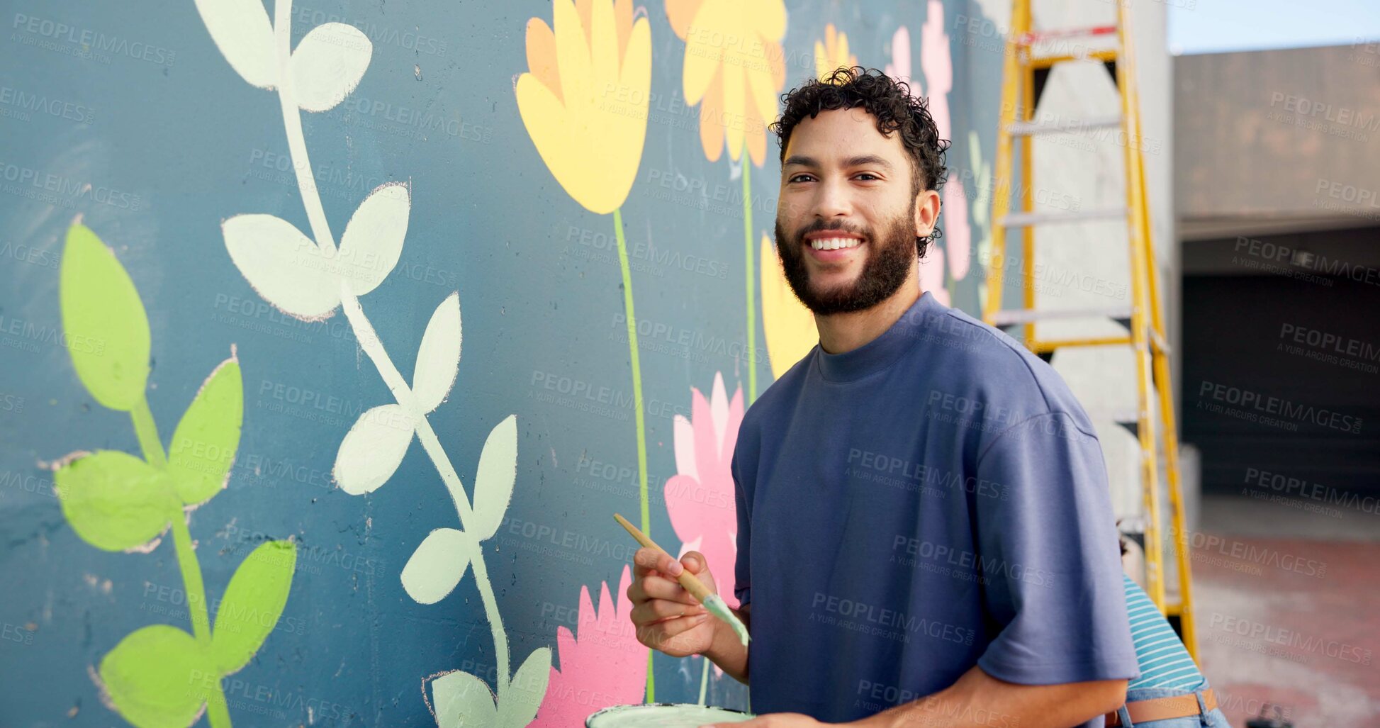 Buy stock photo Man, painting and portrait in city at wall art, creative mural and project to uplift community. Volunteer, creativity and outdoor with smile for floral design, social responsibility and DIY hobby