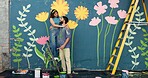 Happy, ladder and couple by wall for painting, creative project and decoration outdoors. Mural, smile and man and woman hug with inspiration for flowers, art aesthetic and diy design together