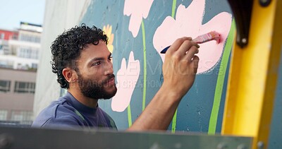 Buy stock photo Man, painting and design in city at wall art, creative mural and project to uplift community. Volunteer, creativity and outdoor with smile for floral decor, social responsibility and DIY hobby