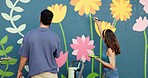 Back, couple and painting on wall for art project, mural design and renovation of community. People, artist and hobby for creativity improvement, diy decoration and expression with flowers aesthetic