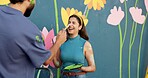 Playful, couple and painting for wall art, mural process, decoration design and community project. Creative, people and woman laugh with artist brush, flowers aesthetic and bonding of diy improvement