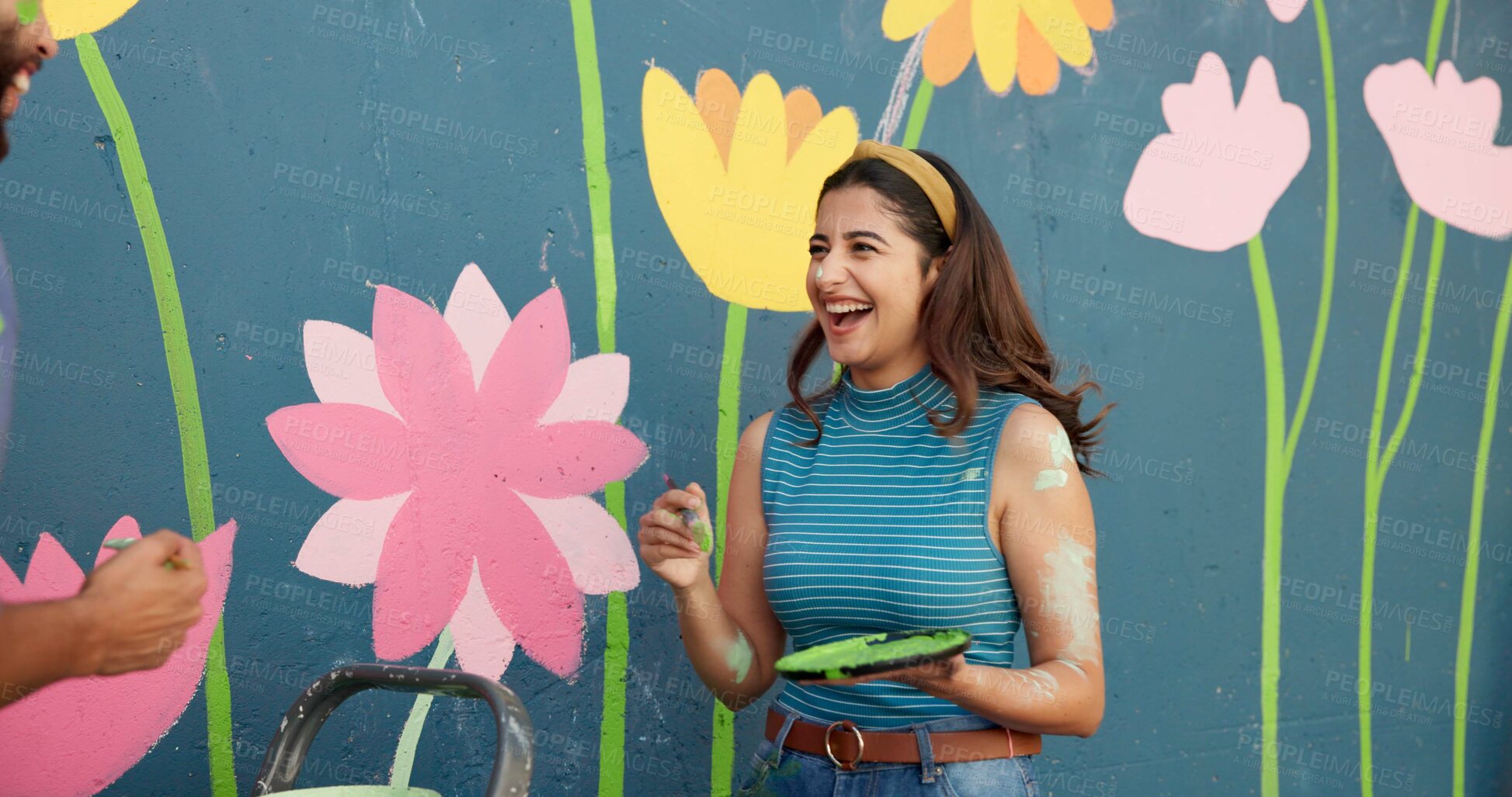 Buy stock photo Woman, laugh and painting for wall art, mural process and decoration design of community project. Smile, couple and playful game with artist brush, flowers aesthetic and bonding for DIY improvement