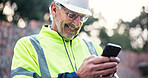 Cellphone, mature man and construction worker on site with contact for renovation approval. Contractor, phone and male civil engineer reading building, maintenance or repairs briefing plan online.