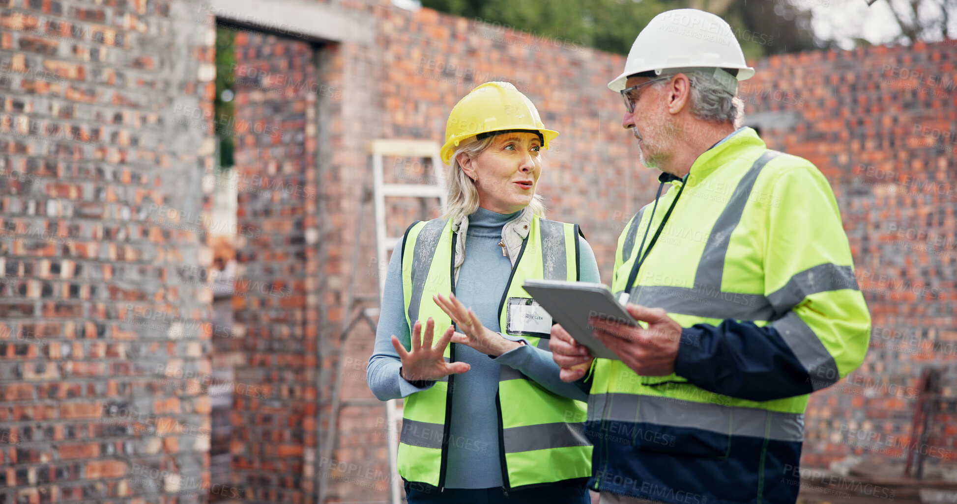 Buy stock photo Construction, discussion and colleagues with tablet, outdoor and teamwork for project management and app. Architecture, mature woman and man with tech for digital blueprint, collaboration and talking