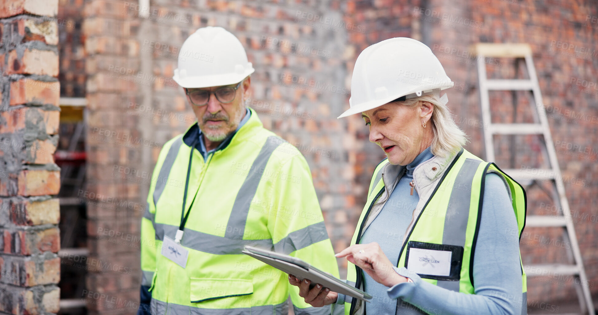 Buy stock photo Construction, online and colleagues with tablet, outdoor and discussion for project management and team. Architecture, mature woman and man with tech for digital blueprint, collaboration and talking