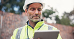 Construction, man and reading tablet on site for project management, safety compliance and building progress. Engineer, mature person and digital checklist for risk assessment and record information