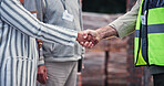 Meeting, handshake and people on construction site for planning, inspection or collaboration at table. Contractor, welcome and deal with partnership for blueprint, brainstorming or architect design