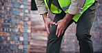 Hands, person and knee pain with construction injury, work site accident or sprain with agony outdoor. Joint ache, contractor with leg muscle tension or pressure, inflammation or fibromyalgia
