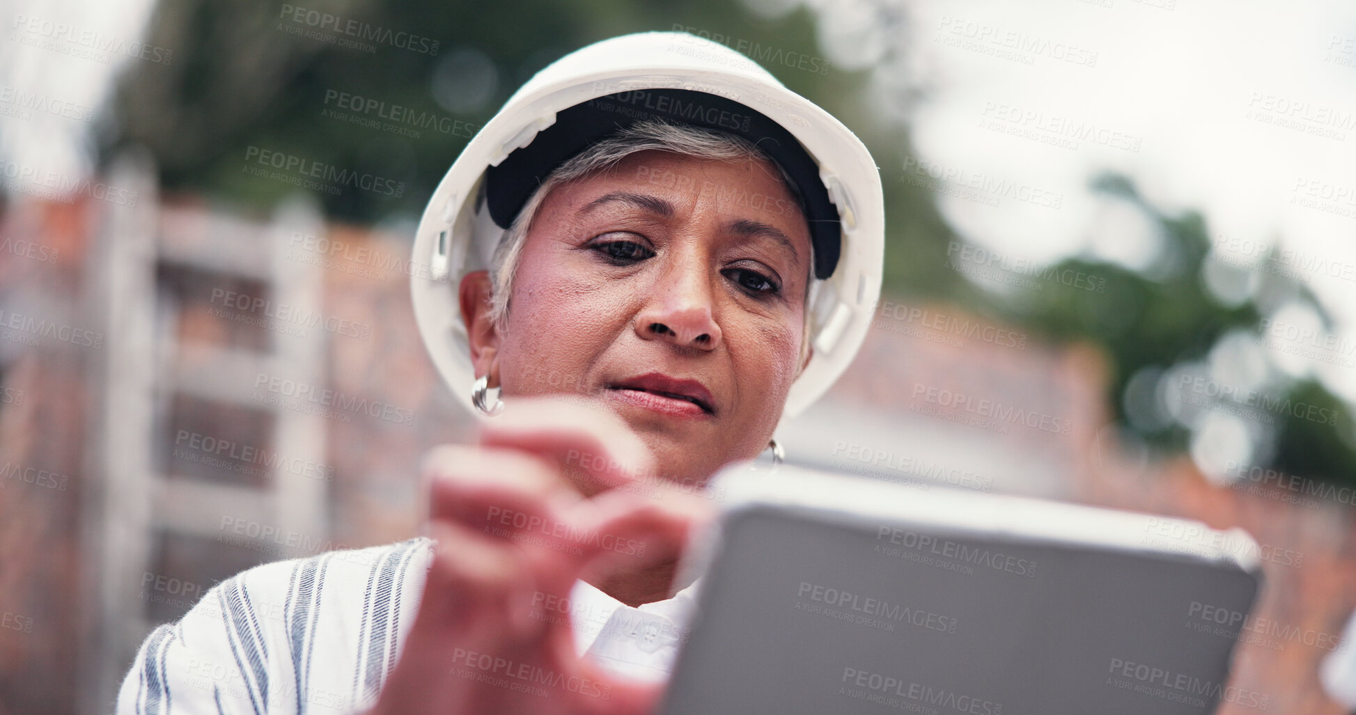 Buy stock photo Construction site, serious and woman with tablet, internet or communication with real estate. Mature person, low angle or property with tech, connection or building development with architecture