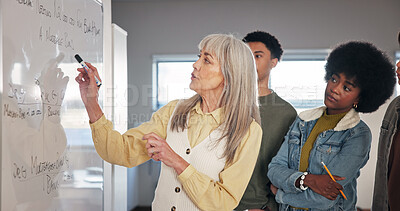 Buy stock photo School, whiteboard and teacher with students explain for assessment, assignment and test question. University, academy and educator with people for learning, teaching and education in classroom