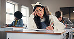 Girl, writing and learning in classroom at high school with solution, problem solving or test. Teenager, notebook and education with scholarship, development or study with perspective at academy