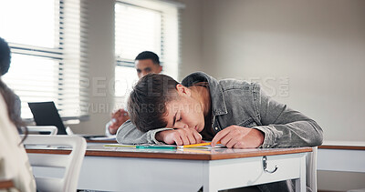 Buy stock photo Tired, school and boy in classroom at desk with fatigue for writing assignment, test and quiz. College, university and exhausted student sleeping for learning, education and bored in lesson on campus