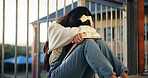 Girl, sad and lonely with crying at school with depression, bullying or social isolation on ground. Child, teenager and anxiety with books, mental health and education with scholarship at academy