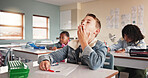 Tired, child and student in classroom for education lesson, learning burnout and elementary school. Boy, yawn and bored with fatigue for knowledge, overworked and studying brain fog for exam pressure