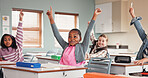 Girl, children and raised hand in classroom, happy and excited for answer, quiz and development at school. Kids, sign and smile for solution, questions and test for education with learning at academy