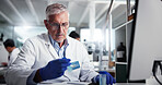 Mature man, scientist or vial with research for medical discovery, development or new study at lab. Male person, health worker or science with gloves or technology for chemistry, exam or test results