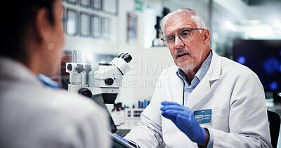 Buy stock photo Mature, scientist and man with colleague in laboratory, feedback or review with tablet for medical innovation or research collaboration. Doctor, team and biotechnology study discussion for science