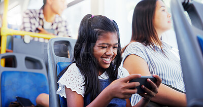 Buy stock photo Happy girl, child and playing with phone on bus for games, entertainment or streaming in vehicle. Kid, traveler or smile with mobile smartphone in public transport for online app or subscription