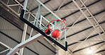 Basketball, net and goal for game, court and points for competition, sports and motion for achievement. Low angle, action and win for match, hoop and successful target in university, stadium or event