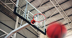 Basketball, net and aim for game, court and points for competition, sports and motion for achievement. Low angle, action and win for match, hoop and successful target in university, stadium or event