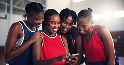 Buy stock photo Sports, team and girls with smartphone, break and watching game on social media, group or basketball. Fitness, player and black people with mobile for videos, smile or scroll on web for entertainment