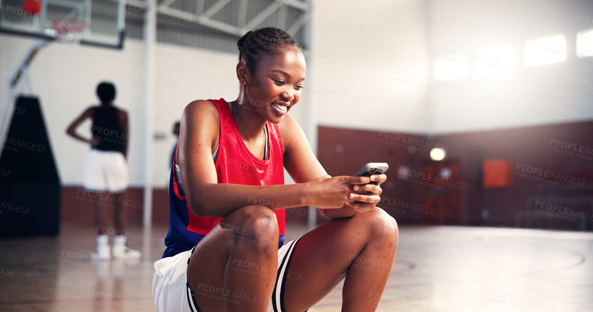 Buy stock photo Fitness, phone and smile of basketball player on court for app, communication or social media. Break, sports and training with happy woman in gymnasium for competition, exercise or performance