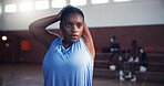 Black woman, basketball and stretching with preparation for game, match or sports competition on court. Female person, African player or athlete getting ready with arm warm up for serious challenge
