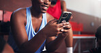 Break, hands and phone with basketball player on court for app, communication or social media. Exercise, sports and training with happy woman in gymnasium for competition, fitness or performance