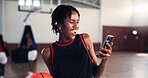 Break, laughing and phone with basketball player on court for app, communication or social media. Fitness, sports and training with funny woman in gymnasium for competition, exercise or performance