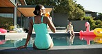 Back, cocktail and swimming pool with black woman outdoor at hotel for accommodation or hospitality. Holiday, swimwear and vacation with person drinking alcoholic beverage at resort for break 
