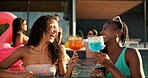 Cocktail, friends and women cheers by pool for summer holiday or vacation. Laugh, alcohol and talk with drink at party for outdoor luxury, hotel or resort on break to relax, celebrate or chill