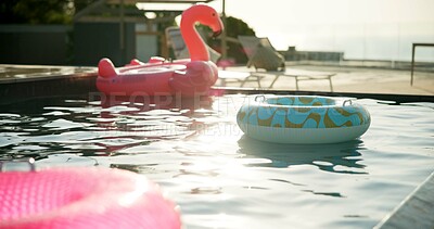 Buy stock photo Pool, inflatables and hotel with empty resort for holiday vacation, reflection or summer weekend. Float, toys and ripple with aqua, liquid or sunlight for swimming or accommodation at luxury getaway
