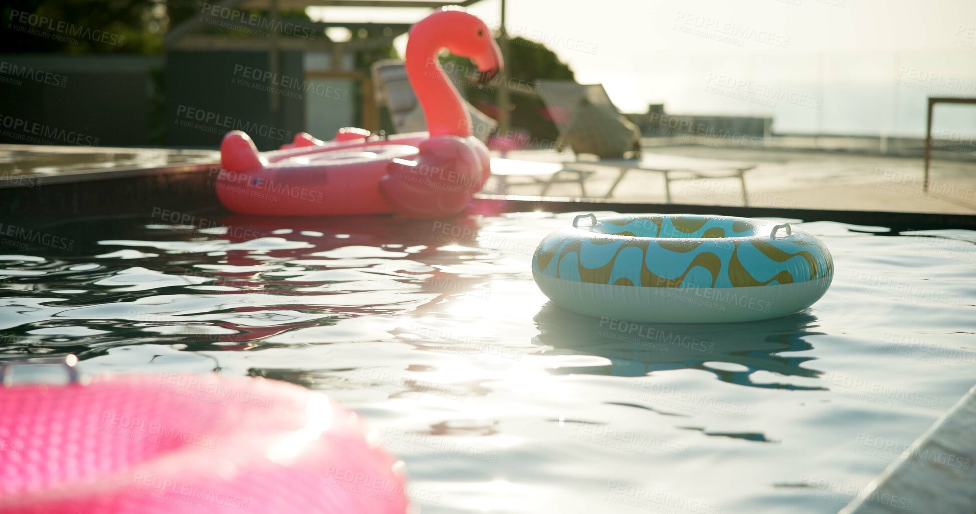 Buy stock photo Pool, inflatables and hotel with empty resort for holiday vacation, reflection or summer weekend. Float, toys and ripple with aqua, liquid or sunlight for swimming or accommodation at luxury getaway