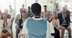 Presentation, speaker and back of woman with business people in office for conference, training and meeting. Corporate manager, discussion and workers in workshop, convention and seminar for coaching