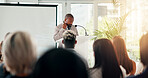 Presentation, speaker and man with business people in office listening for conference, training and meeting. Corporate, discussion and workers in workshop, convention and seminar for tradeshow