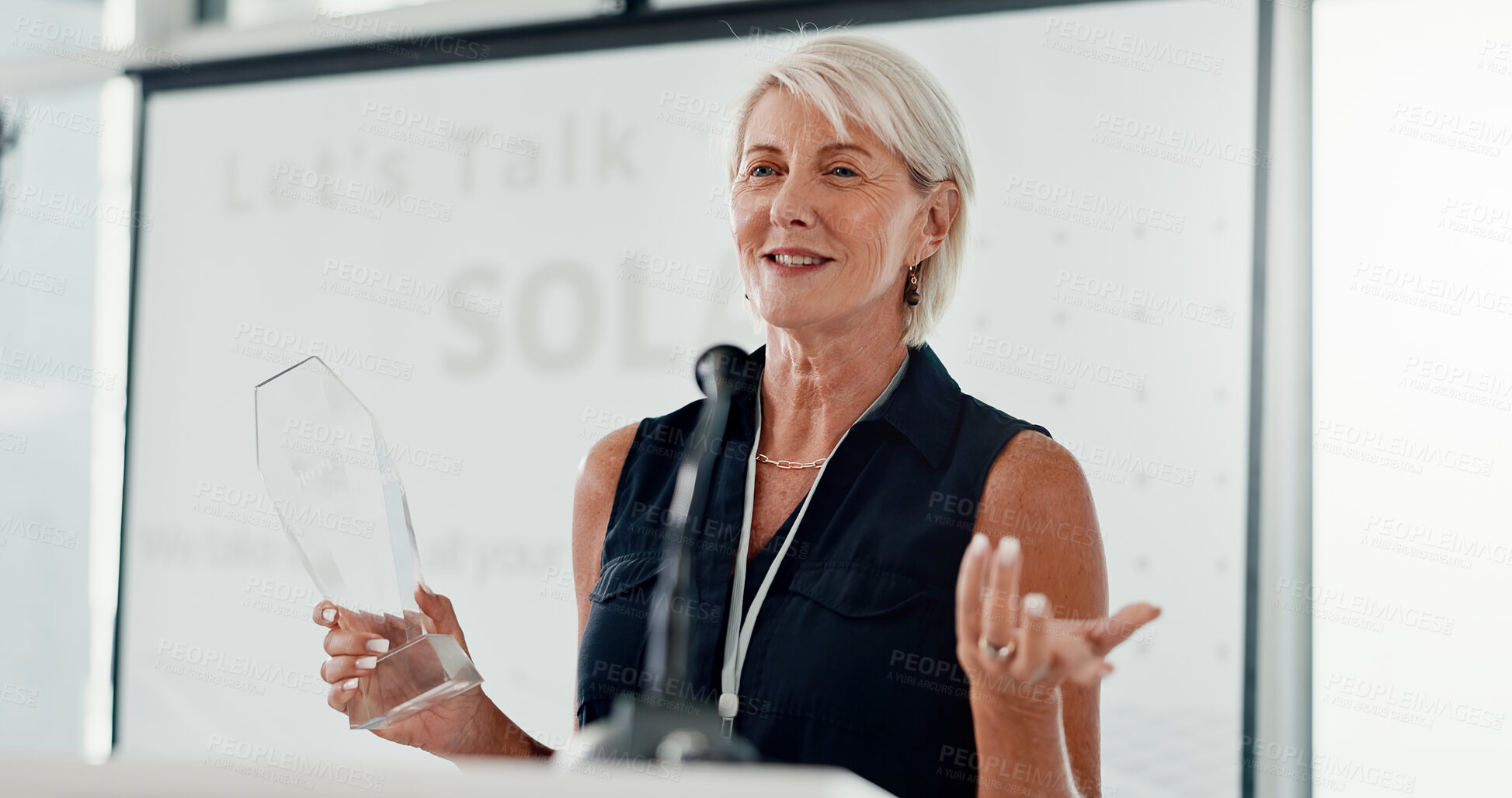 Buy stock photo Mature, business and woman with award, success and speech for innovation project. Sustainability, employee or celebration with support, audience or renewable energy with speaker, talking and solar