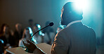 Businessman, speaker and microphone for seminar, presentation and audience for conference or convention. Person, back and podium speech for international trade show, event or training workshop