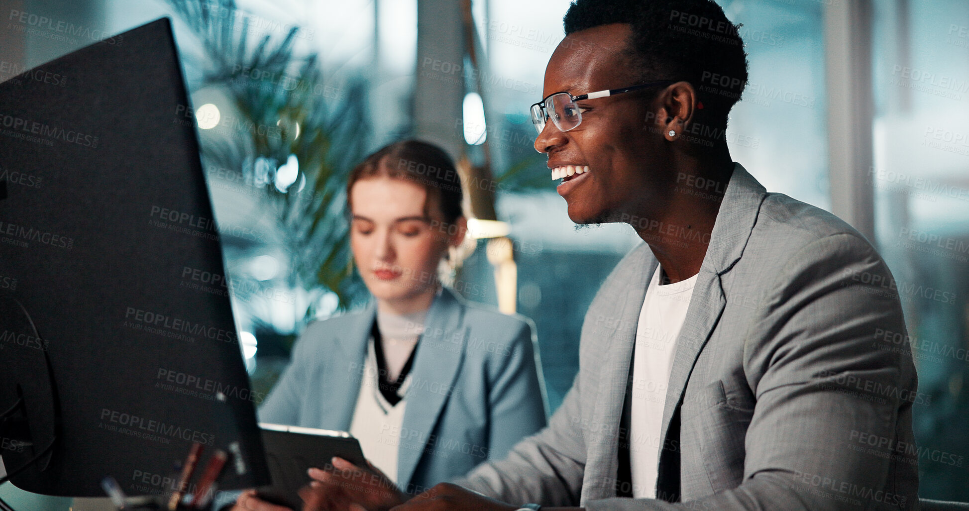 Buy stock photo Coworking, night and happy businessman on computer for project deadline, insurance or risk management. Technology, planning and team in office for financial coverage, policy or research on internet